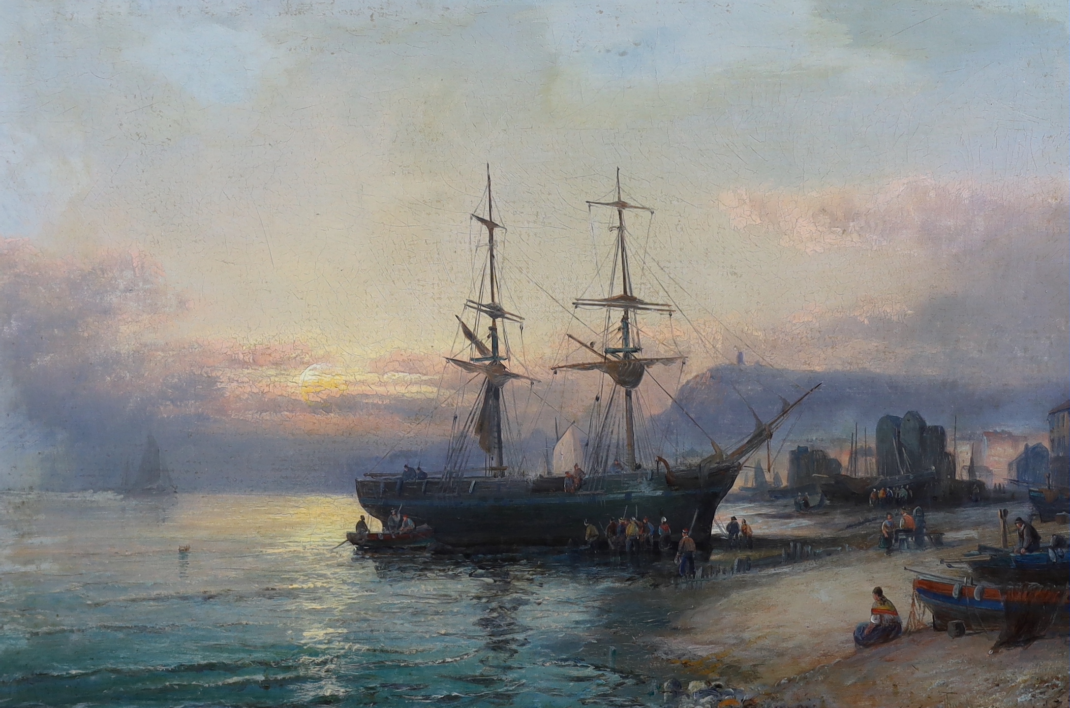 Hubert Thornley (fl.1859-1898), Beached merchant ship unloading the hold with figures on the shore at sunset, oil on canvas, 40 x 60cm